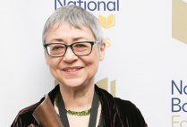 Sigrid Nunez poses for a photo holding her National Book Award.