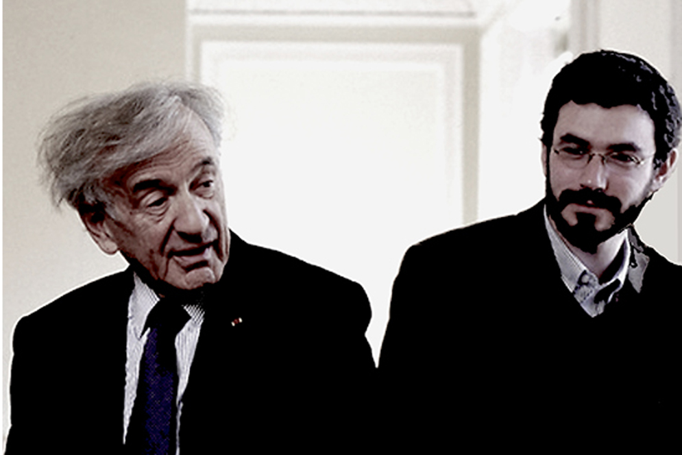 Professor Elie Wiesel sits talking with his teaching assistant, Ariel Burger.