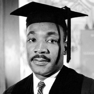 Portrait of Martin Luther King Jr, in a graduation robe and mortarboard hat upon receiving an honorary degree from Boston University in 1958