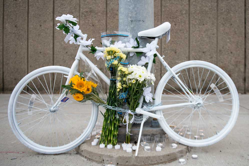 A ghost bike adorned with candles and flowers honors BU grad student Meng Jin (GRS’19), from Shanghai, China, who died in a bicycle crash November 9 near the Museum of Science. Photo by Maddie Malhotra (COM’19)