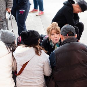 Karen Pita Loor, a School of Law clinical associate professor of law, talks to Central American migrants in Tijuana, Mexico, about the US asylum process, during a recent trip by LAW faculty and students to the border.