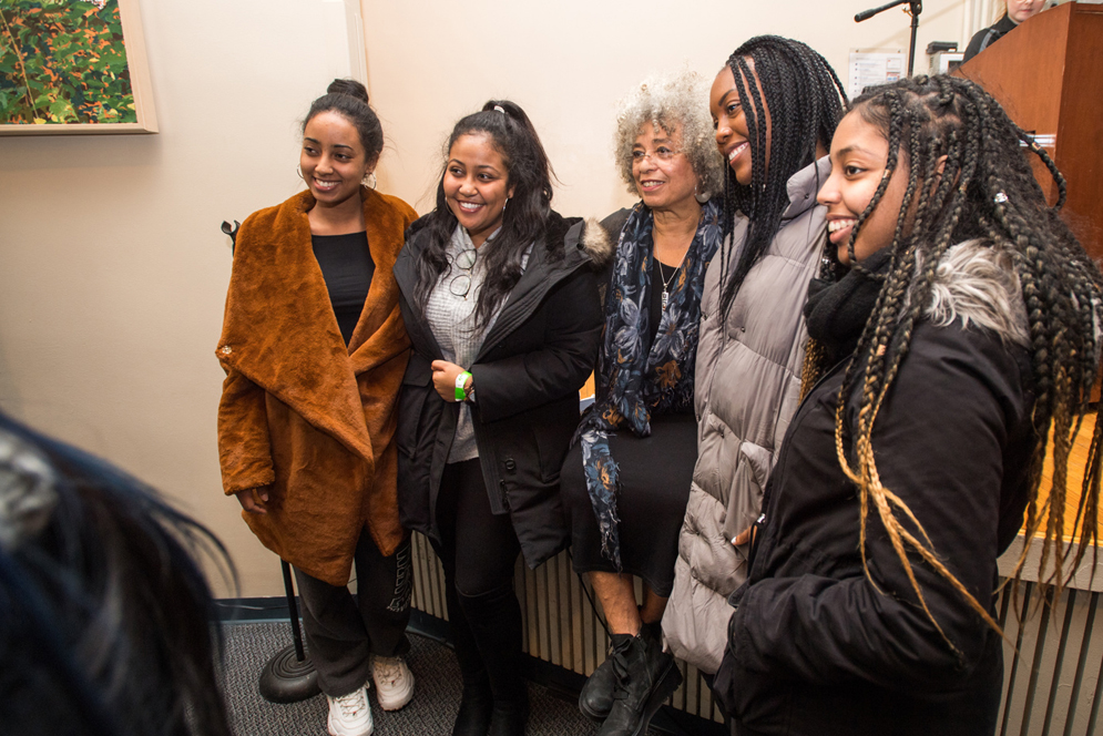Angela Davis, activist, academic and author took time to chat with students and pose for photos with them, including Feven Solomon (CAS'21), from left, Kalkidan Tewodros (Questrom'21), Davis, Grace Mecha (SAR'21), and Zanta Ephrem (SAR'21) after speaking to a full crowd in Jacob Sleeper Auditorium February 9, 2019. The event, entitled Angela Davis: Violence Against Women and Its Ongoing Challenge to Racism! was made possible by The Boston University Undergraduate Sociology Association.