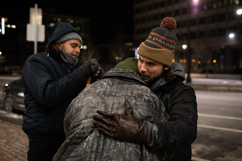 A City of Boston volunteer hugs a homeless person during the annual Boston Homeless Census.