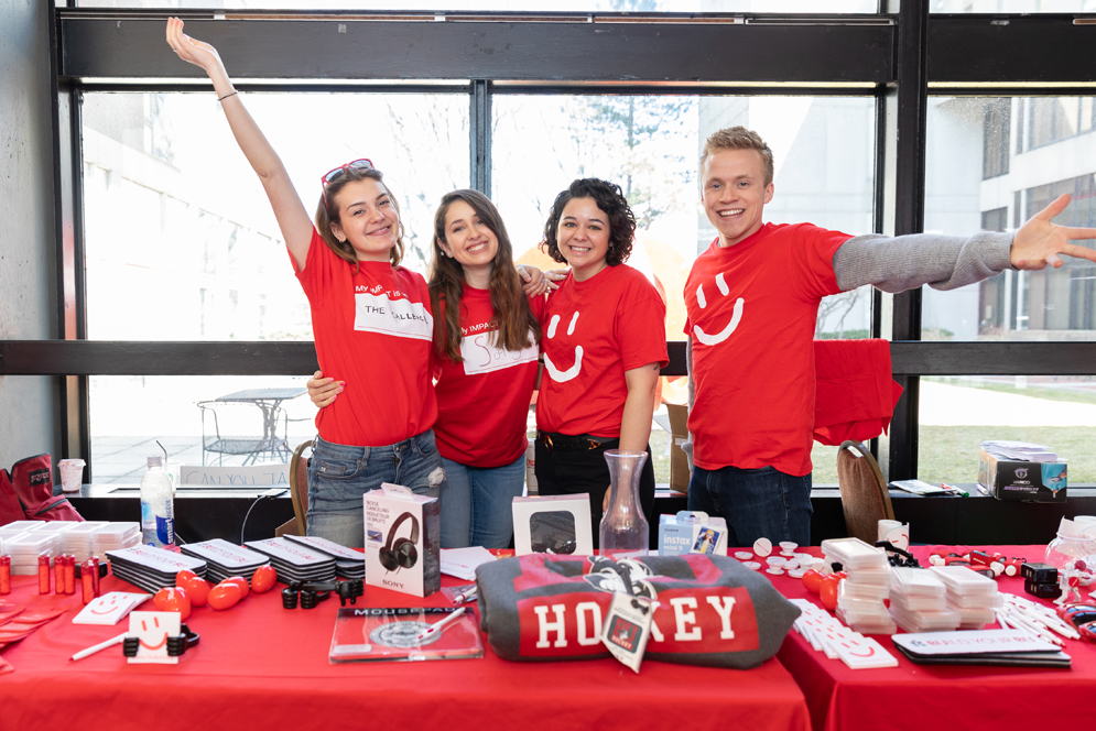 Students posing in red giving day shirts