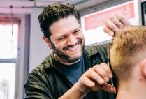 University Barber Shop owner Rino DeStefano gives a haircut