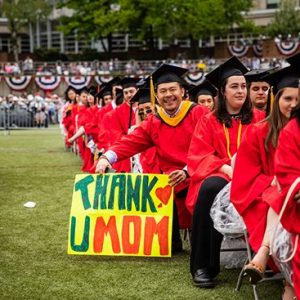 A graduate of the Boston University Class of 2019 celebrates after graduating at the 146th All University Commencement.