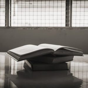 Stack of books on a table in a prison
