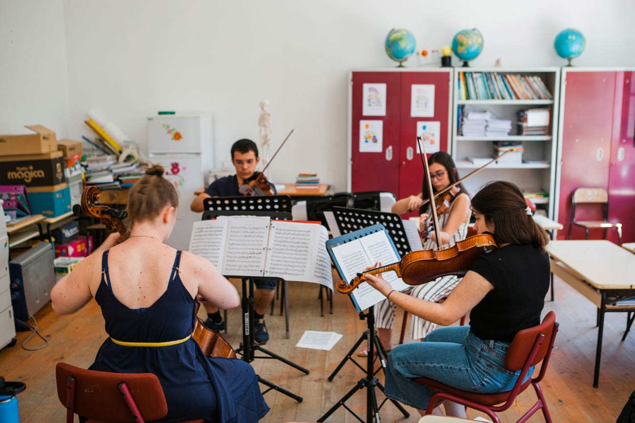 Full color slideshow photo of Cello instructor Gracie Keith leads a chamber music quartet, with students playing two violins and a viola, in playing Beethoven's String Quartet No. 2 in G major.