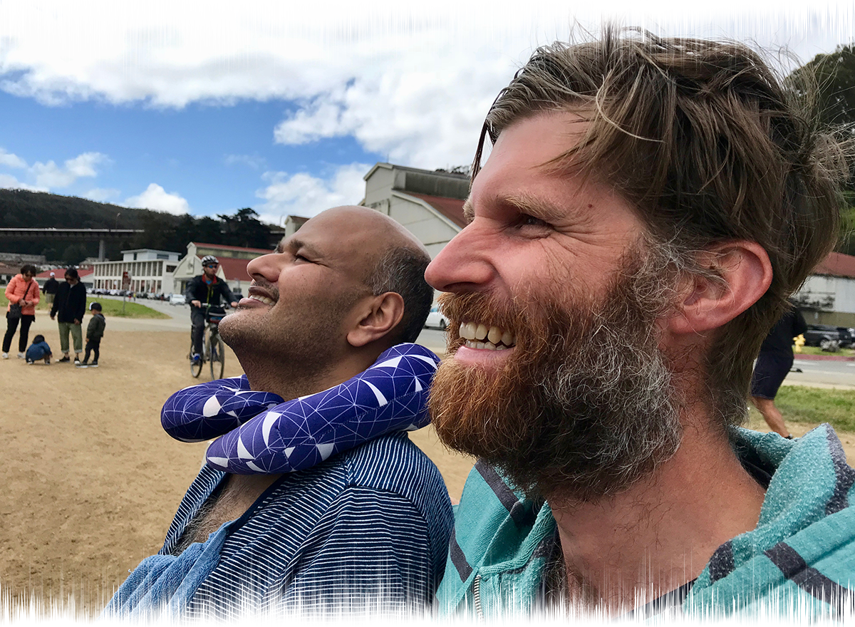 Rahul Desikan and Craig Cloutier smile while at the Crissy Field beach together in 2018.