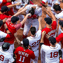 Xander Bogaerts is mobbed by teammates after hitting a walk-off grand slam home run against the Toronto Blue Jays on July 14, 2018, at Fenway Park.