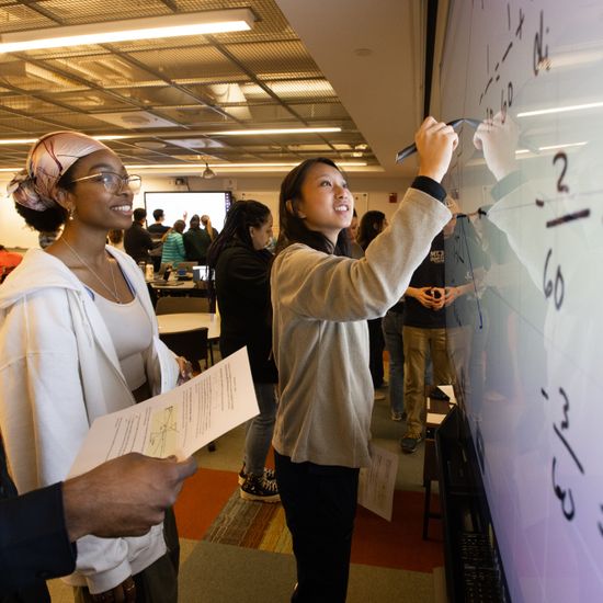From left: Ranjan Narendra (CAS’24), Janna Foy (CAS’24), and Allyson Zheng (CAS’24) work together on a smart board in Physics 2