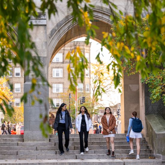 Students stroll through Marsh Chapel’s arches