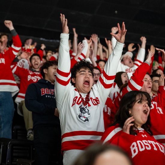 Jack Breiter (CAS’28), in white, reacts to BU’s fourth point scored against Harvard during the men’s Beanpot semifinal game at TD Garden