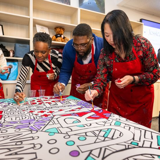 From center-left: BU President Melissa Gilliam, Faculty Director Anthony “Tony” Abraham Jack, and Newbury Center Executive Director Maria Dykema Erb contribute to an art installation at the center’s grand reopening