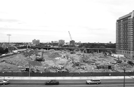 This summer's demolition of the Commonwealth Armory is part of the next phase of construction for the Student Village. On the cleared site, construction will begin on a premier sports and entertainment arena and a fitness/recreation center. Photos by Vernon Doucette and Kalman Zabarsky