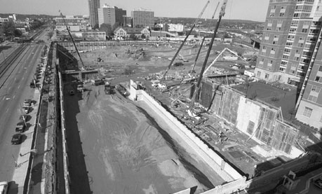 Grounds for growth: The roof of 881 Commonwealth Avenue provides an unobstructed view of the John Hancock Student Village construction taking place on the block between Buick Street and Harry Agganis Way. Excavation and soil removal for the Harry Agganis Arena and the recreation center should be completed by the end of next week; concrete foundations and footings are being staged and poured. According to project managers, structural steel will start going up next month. Photo by Kalman Zabarsky