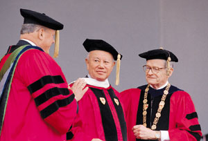 Gerald Tsai, Jr. (CAS’49, GRS’49) is hooded by Trustee James Howell and Chancellor John Silber. Photo by Kalman Zabarsky