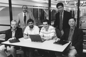 John Baillieul, Christos Cassandras, and Yannis Paschalidis (seated, from left) of ENG’s Center for Information Systems Engineering are developing sensor network control systems with far-reaching applications in manufacturing, homeland security, and space exploration. Their interdisciplinary team includes University of Massachusetts, Amherst, faculty Abhi Deshmukh, Weibo Gong (standing, from left), and Robert Gao (seated, far right). Photo by Fred Sway