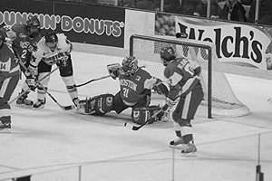 Television viewers of Februarys Beanpot tournament, played at the FleetCenter, undoubtedly noticed the remarkable performance of goaltender Sean Fields (CAS04). They also might have been aware that Dunkin Donuts and Welchs didnt have to wait for commercial breaks to advertise on the airwaves. Photo by Albert Ltiole