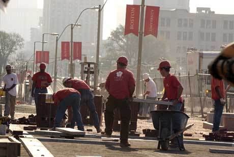 Paving the way. Construction workers lay down a brick and granite walkway in front of the new Harry Agganis Arena on August 27. Photo by Kalman Zabarsky