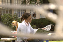 Instruments of observation. Elizabeth Miller (COM08) is spied through the sculpture of an armillary sphere, which is a model created by the ancient Greeks for solving astronomical problems, on the COM lawn last month. Photo by Kalman Zabarsky