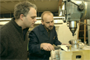 Mike McKenna, director of the Scientific Instrument Facility (right), fine-tunes an aluminum component for a mass spectrometer that Peter OConnor, a MED research assistant professor of biochemistry, is building. Photo by Kalman Zabarsky