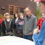 Professor Ethan Baxter (right) and students discuss minerology at the New Hampshire home of Dean Sapiro (center) and Political Science Chair Graham Wilson (center-right).