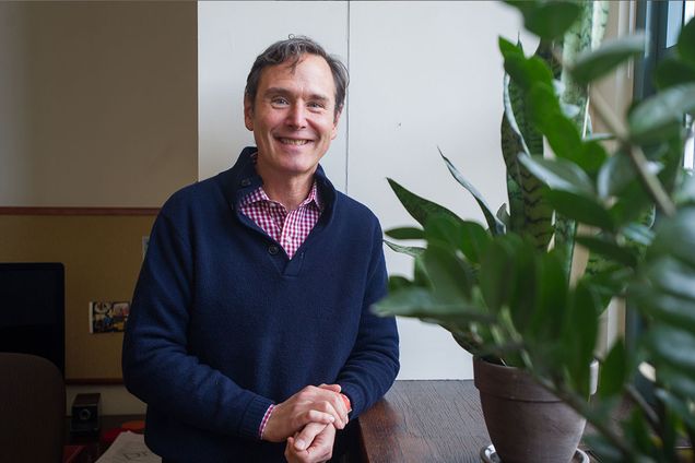BU CAS Dean Stan Sclaroff standing next to a plant