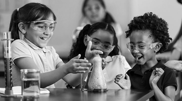 Diverse group of children enjoying science experiment