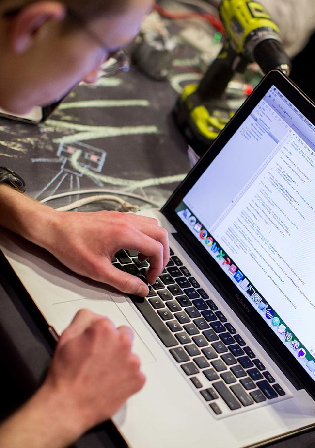 Student working on a laptop during a Hackathon