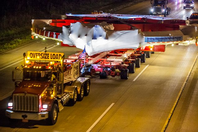 Caption: On the third and final night of the magnet’s move, the team traveled along the Illinois toll roads and eventually arrived at Fermilab. Category: People and Events Description: The g-2 Muon Magnet Ring - third nights move arriving at Fermilab Names of People Pictured: Date 07/25/2013 Image Number (linked to high res image): 13-0221-08 Photographer Cindy Arnold