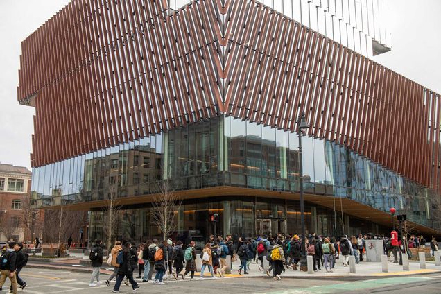 Photo of the BU Center for Computing & Data Sciences Center from the exterior with students walking in front of the building