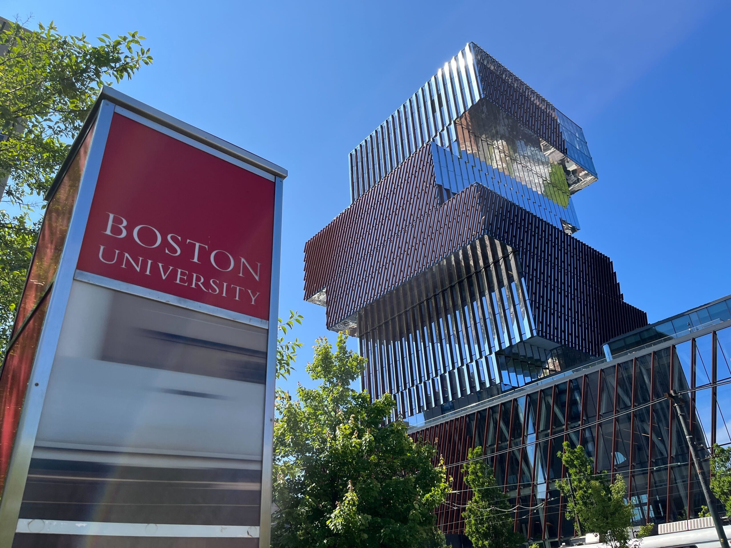 Photo of the BU Center for Computing & Data Sciences with a Boston University sign in the foreground
