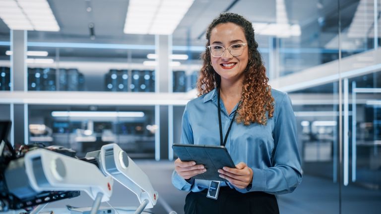 female data scientist working in a smart manufacturing facility