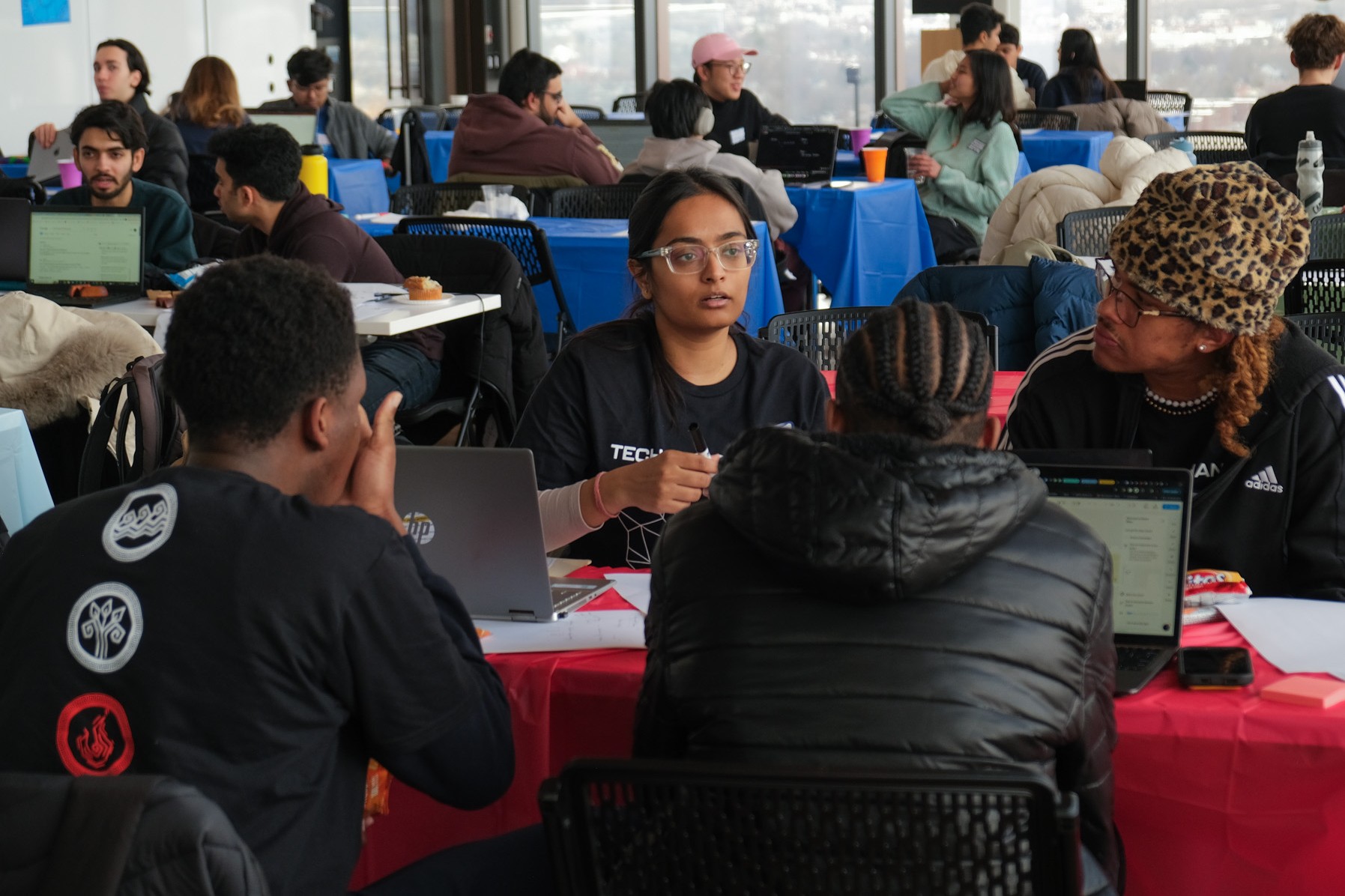 Photo of students working and talking together on the 17th floor of the Duan Family Center for Computing & Data Sciences