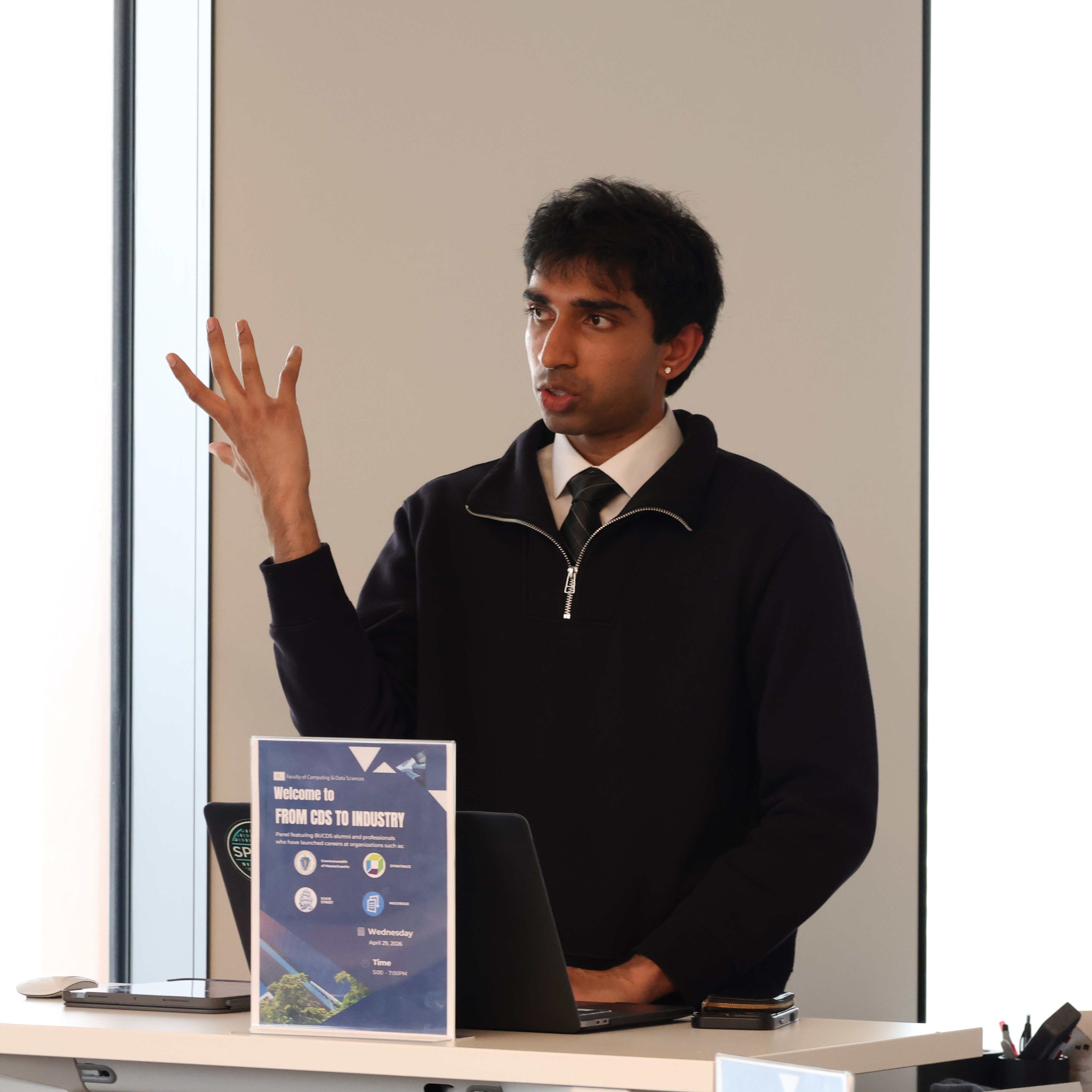Photo of Kapilan Ramasamy speaking at podium