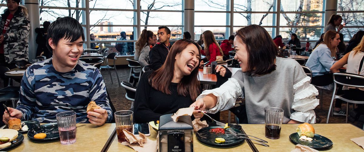students enjoying a meal together in West Campus dining hall