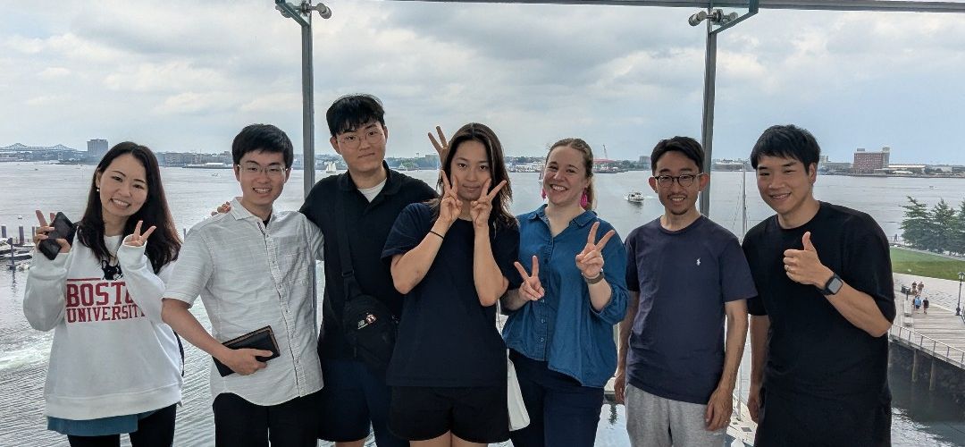 CELOP students posing for picture at ICA in Boston with harbor in background