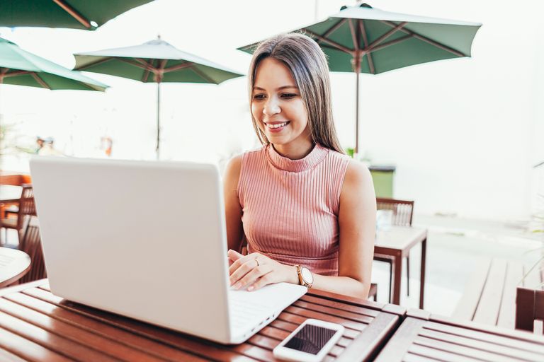 young woman using laptop in a cafe