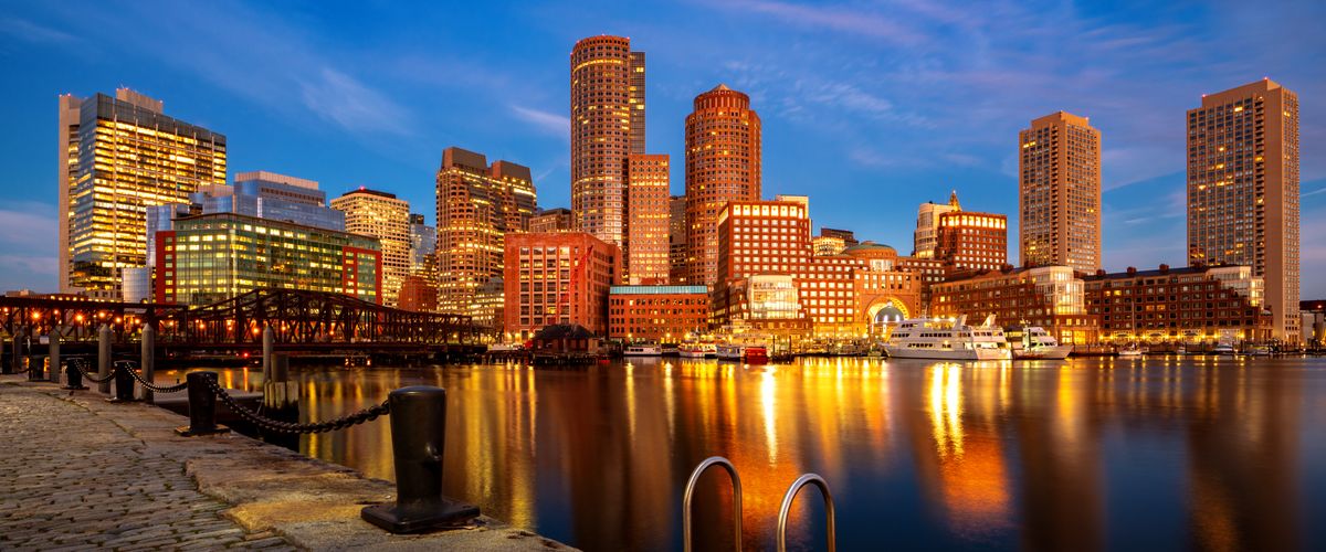 Boston harbor with cityscape and skyline at dusk