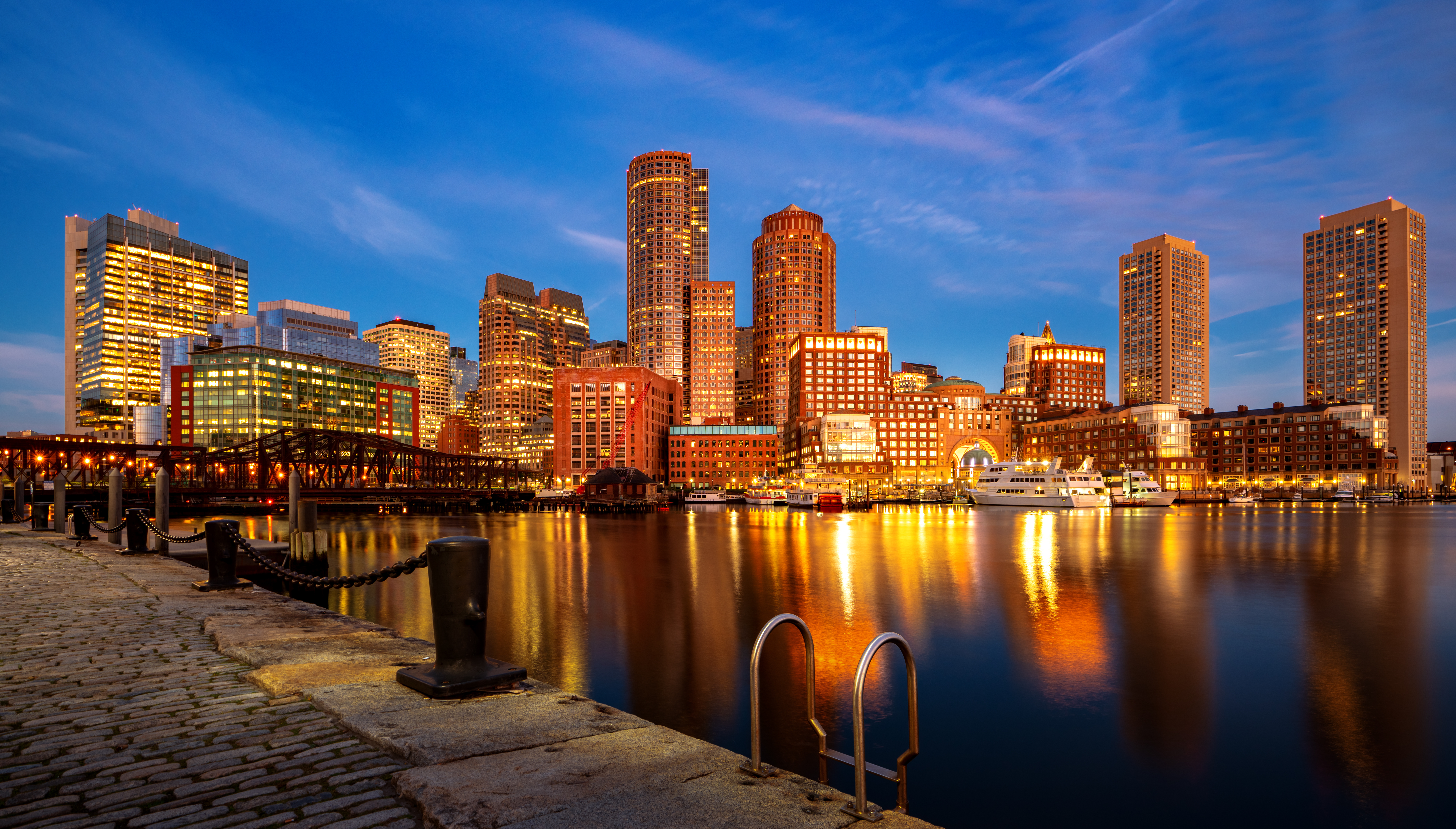 Boston harbor with cityscape and skyline at dusk