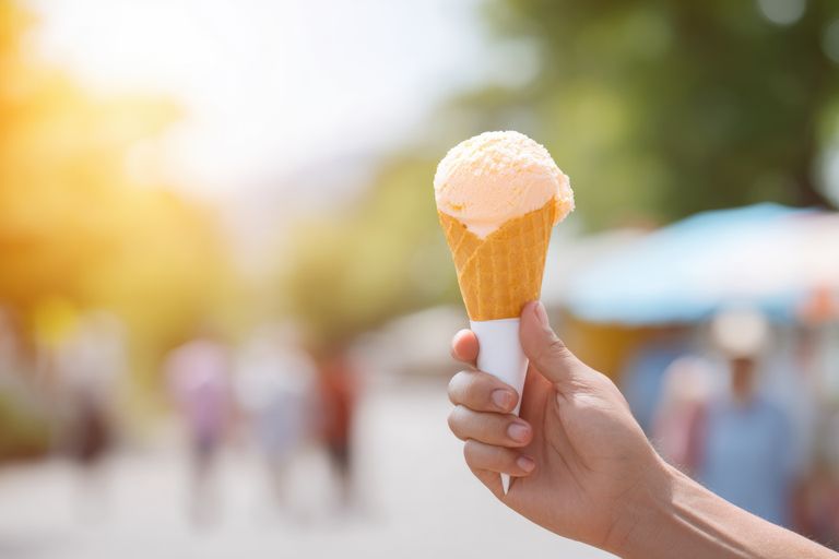 celebrate national ice cream day with clean images portraying joyful adult holding vibrant ice cream cone against sunny