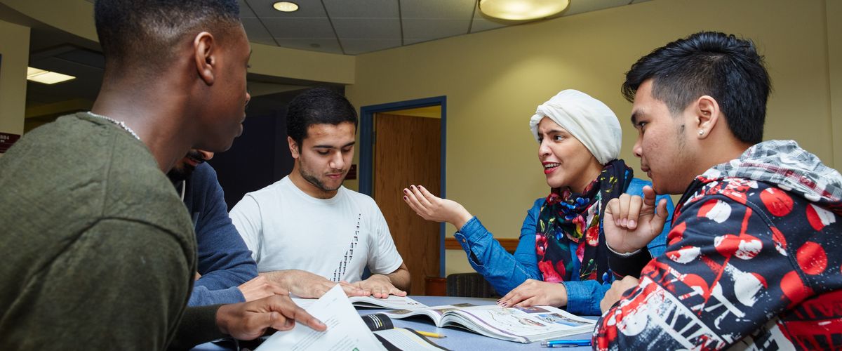 CELOP students talking around a table