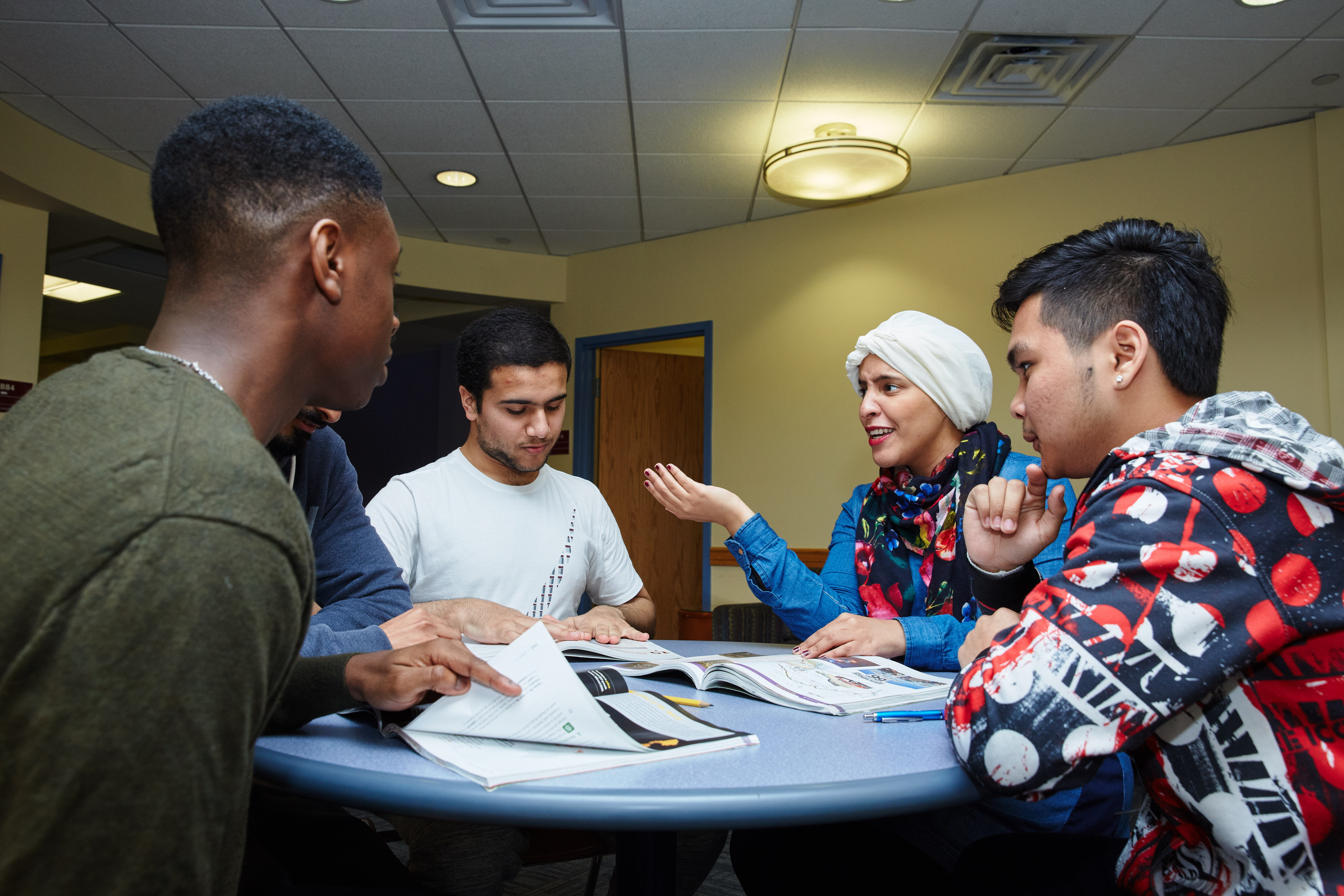CELOP students talking around a table