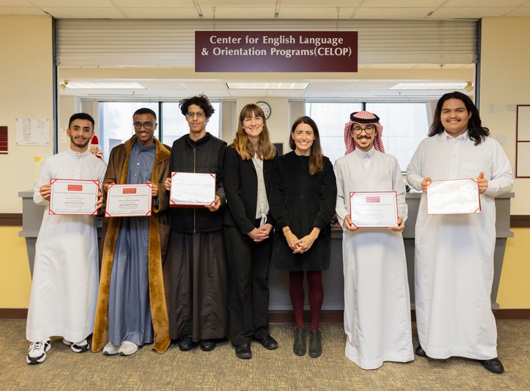 CELOP students posing with thier instructor and Director of CELOP showing their certificates of achievement