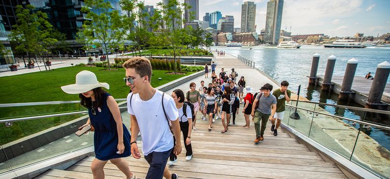 Students walking up steps along the Boston Harbor
