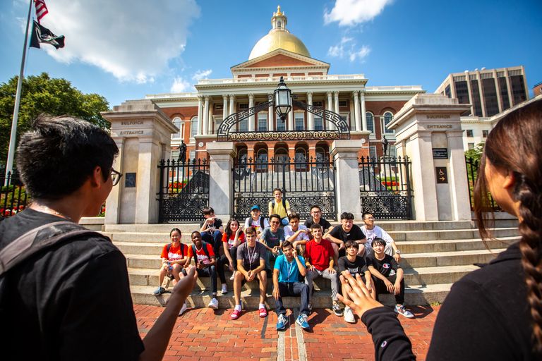Group picture of CELOP students on the steps at the Bulfinch entrance of the State House
