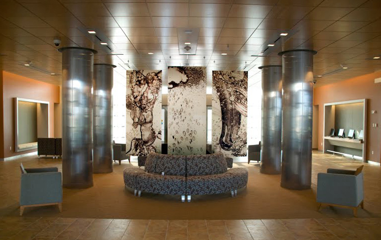 In 2010, Rebecca Wasilewski (’07) designed a series of opaque panels for the lobby of StuVi-2 student housing. With an open-ended directive that the work should have an element of translucency, Wasilewski created hanging panes that allow light to filter through them in a soft glow, giving the effect of an inky, larger-than-life monoprint.