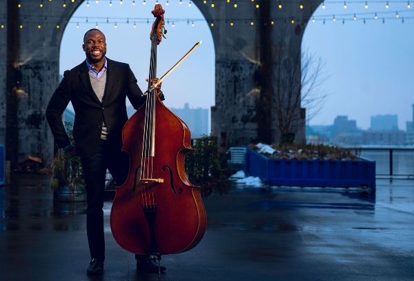 Joseph Conyers (BUTI'98), director of orchestra program at BUTI, holding a bass.