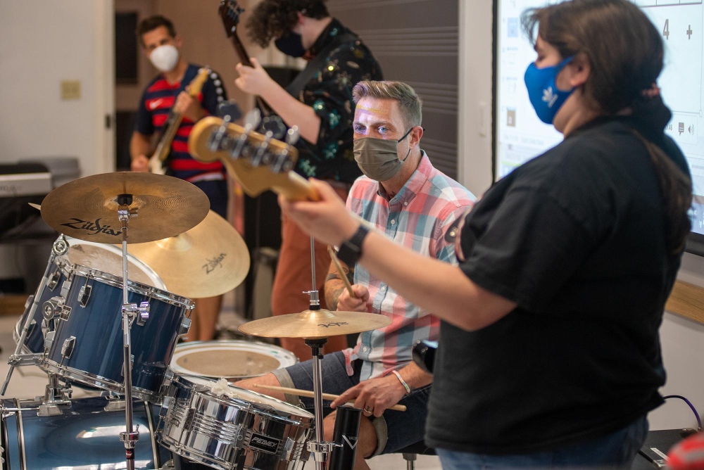 Music teacher Paul Halpainy (CFA’12,’24) takes over on drums during a jam session with classmates in CFA’s Rock Band Performance & Pedagogy class.